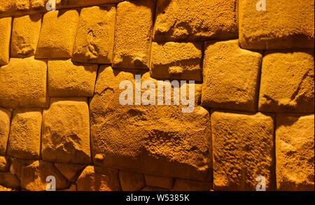 View to Twelve-angled stone aka Hatun Rumiyoc as a part of a wall of the palace of the Archbishop of Cuzco in Peru Stock Photo