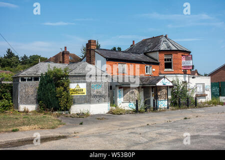 An old closed down pub on the bath road in Reading, UK. It is left vacant and derelict and is a target for vandalism and graffiti. Stock Photo