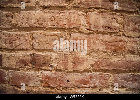 Old red brick wall, old texture of red stone blocks. Stock Photo
