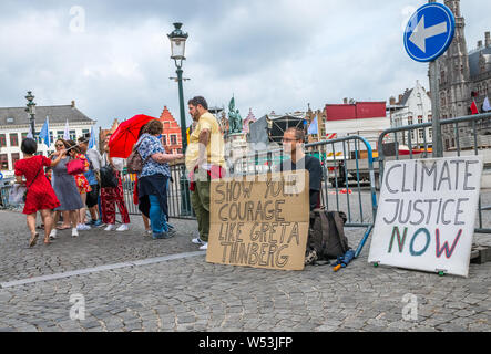 Wouter Mouton, a climate change activist with his carboard placards in the centre of Bruges, Belgium. Stock Photo