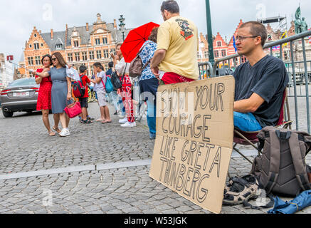 Wouter Mouton, a climate change activist with his carboard placards in the centre of Bruges, Belgium. Stock Photo