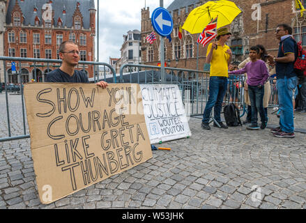 Wouter Mouton, a climate change activist with his carboard placards in the centre of Bruges, Belgium. Stock Photo