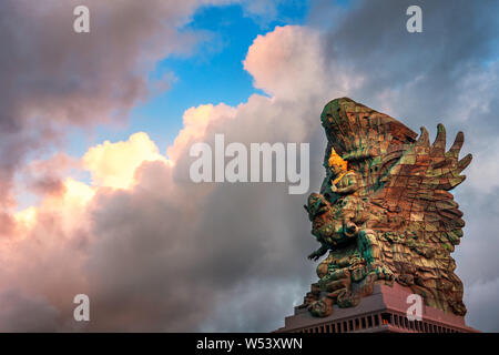 Landscape picture of tallest Garuda Wisnu Kencana GWK statue as Bali landmark with blue sky as a background. Balinese traditional symbol of hindu god Stock Photo
