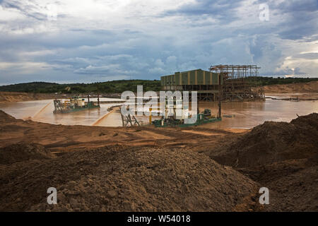 Managing & transporting of titanium mineral sands at mine site. Mining by dredging in freshwater ponds. Dredges pump sand into wet concentrator plant. Stock Photo