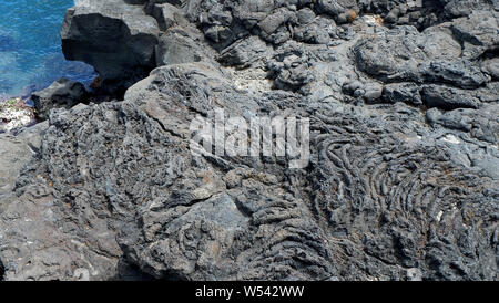 The surface of the volcanic stone. Black stone background. Rock texture. Rock pile background Stock Photo