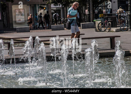 (190726) -- PARIS, July 26, 2019 (Xinhua) -- A man walks past a fountain in Strasbourg, northeastern France, July 25, 2019. Thursday is the hottest day of the intense heatwave episode in France's northern regions. Earlier, Meteo France forecasted that in the hottest part of the day, the temperatures under shelter will be between 40 and 42 degrees Celsius, very occasionally 43 degrees in certain districts of its capital. (Photo by Martin Lelievre/Xinhua) Stock Photo