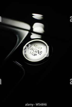 start/stop button surrounded by a glossy plastic interior of a modern car Stock Photo