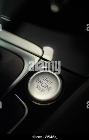 start/stop button surrounded by a glossy plastic interior of a modern car Stock Photo