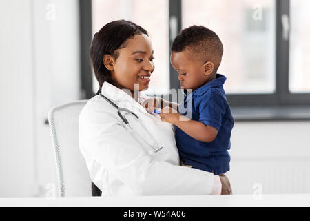 doctor or pediatrician with baby patient at clinic Stock Photo