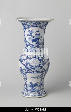 Baluster beaker vase with flower scrolls and panels in reserve, Baluster-shaped porcelain vase with trumpet-shaped mouth, painted in underglaze blue. The belly and neck are covered with underglaze blue with flower vines in reserve, two fan-shaped cartouches with two people in a landscape and flower sprays with a bird, two in-between rectangular cartouches with a flying horse above waves and two deer under a tree in which a crane sits. On the neck two saved, lobed cartouches with a flower basket and the other with antiques (vase with peacock feathers, incense burner, books) and valuables Stock Photo