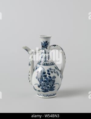 Ewer with flowering plants, flower sprays and floral scrolls, Porcelain jug with a pear-shaped body, c-shaped ear and curved spout attached to the neck, painted in underglaze blue. On the belly twice a group of flowering plants with a bird and insects. The shoulder with a decorative band and two flower sprays. On the neck a band with floral scrolls, two flower sprays and a butterfly. The spout with flower vines and the ear with a leaf branch. A decorative band around the foot. A hole for a frame on top of the ear. Baking sand on the foot ring, a chip in the rim and in the spout. Arita, blue Stock Photo