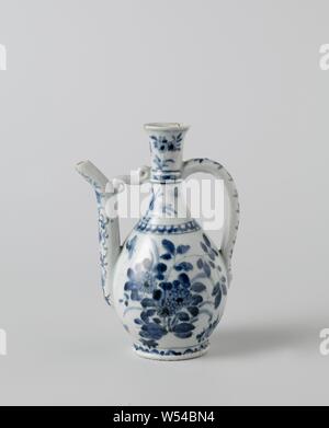 Ewer with flowering plants, flower sprays and floral scrolls, Porcelain jug with a pear shaped body, c-shaped ear and curved spout attached to the neck, painted in underglaze blue. On the belly twice a group of flowering plants with a bird and insects. The shoulder with a decorative band and two flower sprays. On the neck a band with floral scrolls, two flower sprays and a butterfly. The spout with flower vines and the ear with a leaf branch. A decorative band around the foot. A hole for a frame on top of the ear. Baking sand on the foot ring, edge has been broken. Arita, blue and white Stock Photo