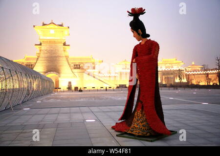 A five-meter-tall straw-made woman featuring shape of Yang Guifei stands in front of an ancient city gate to welcome tourists in Xiangyang city, centr Stock Photo