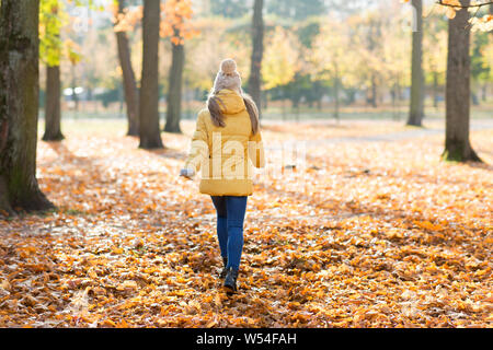happy girl running in autumn park Stock Photo