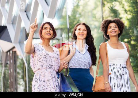 happy women with shopping bags in city Stock Photo