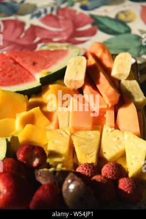 Breakfast on our Australian Daintree holiday included this delectable selection of colorful fruits and berries. Note the colorful tablecloth. Stock Photo