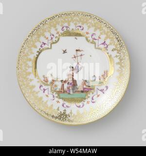 Plate with a man, three children and birds, Porcelain dish, painted on the glaze in blue, red, pink, green, black and gold. On the shelf a richly decorated medallion with a performance based on a Höroldt chinoiserie. This shows a man with two birds holding a stick in his hands and looking back at two children, who stretch their arms towards the birds. On the right a third child, who looks up over his shoulder. In the air some insects and a third bird. Leafy vines around the medallion and inner wall with a band of curl and dots. Gold border. The foot ring is set in a silver frame. Marked on Stock Photo