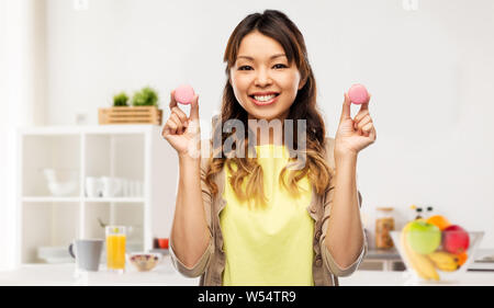 happy asian woman with macarons Stock Photo