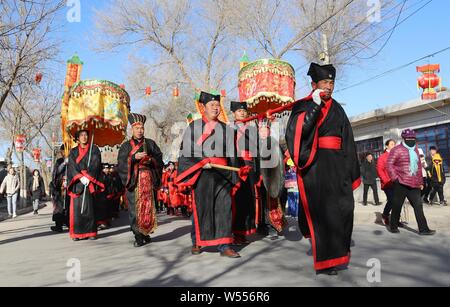 Chinese villagers dressed in traditional costumes take part inthe Yellow River lantern parade in Wulan Ancient Town, Gucun village, Zhangye city, nort Stock Photo