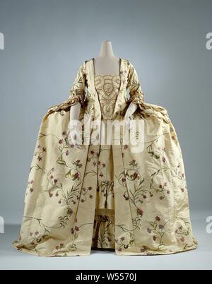 Dress made of lemon-yellow ripped silk embroidered with tendrils and purple flowers, consisting of an overcoat (a), a tablier (b), a devant-de-gorge (c) and a loose metrage silk (d ), Frock (robe à la française) of lemon-yellow ripped silk embroidered with tendrils and purple flowers, consisting of an overgown (a), a devant-de-gorge (c) and a loose piece of silk (c) d). Model: (a) overcoat, manteau or robe with fitted bodice and flat pleats on the back (pli Watteau), square neckline, pleats in the front and extra toppings, half-length sleeves with triple fan-shaped cuff. The skirt consists Stock Photo