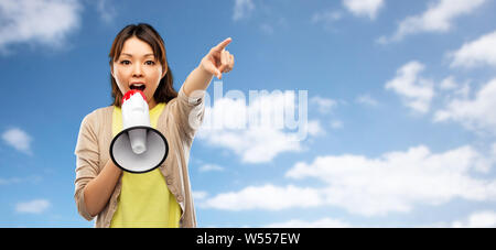 asian woman speaking to megaphone Stock Photo
