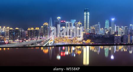 Night view of Hongyadong settled house complex in Jiangbei district, in Chongqing, China, 23 February 2019. Stock Photo