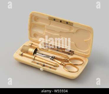 Sewing kit consisting of a pair of scissors, a needle case, a thimble, an awl, a row needle in a box. The pair of scissors has faceted handles, round stems and steel legs. The needle case has a loose cap. It is round, just like the awl and the rowing needle. The scissors, the rowing needle and the awl are decorated with pearl edges and faceted edges. The sewing kit is contained in a rounded rectangular box made of ivory, in which cavities for these objects are saved., Cornelis Balthus Hermanus Canté, Amsterdam, c. 1852 - c. 1870 and/or c. 1880 - c. 1884, gold (metal), ivory, steel (alloy), h 1 Stock Photo