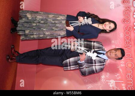 Hong Kong actress Angelababy, left, and Hong Kong actor Louis Koo attend a press conference for the 38th Hong Kong Film Awards in Hong Kong, China, 12 Stock Photo