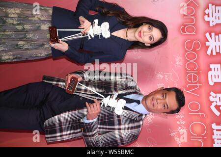 Hong Kong actress Angelababy, left, and Hong Kong actor Louis Koo attend a press conference for the 38th Hong Kong Film Awards in Hong Kong, China, 12 Stock Photo