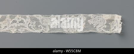 Strip of bobbin lace with swans and carnations, Strip of natural-colored bobbin lace: Mechelen lace. The repeating pattern consists of a symmetrical composition with two swans, flanked left and right by a detached carnation between two rosette flowers. The motifs are connected by a fine mesh ground, the Mechelen ground. The motifs are made in linen with cutouts, and provided with thicker and shiny contour threads. Some decorative soils have been used sparingly, between the branches that hold the swans with their beaks and in the rosette flowers. The top and bottom are finished straight, Stock Photo