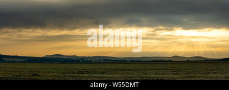 Scenic view on rural landscape in golden morning sunrise with sun rays breaking through the clouds. Upper Lusatia Bernstadt Germany Stock Photo