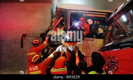 Chinese rescuers are seen at the accident site after a bus carrying 52 passengers crashed into the wall of a tunnel in Guilin city, south China's Guan Stock Photo