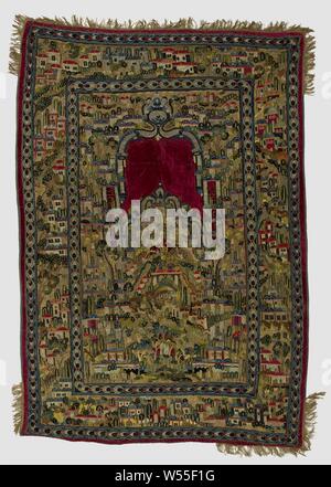 Prayer rug (?), Multicolored appliqué and embroidered, with a pattern of a hilly landscape in the midfield with buildings with domes and trees., Bid rug (?) made of natural-colored cotton (?) with appliqué and embroidery in various colors, trimmed around with golden yellow frills - with gaps - and lined with blue cotton. The central representation is set in a broad border with a narrow border on either side with a pattern of linked ellipses. The representation in midfield includes a hilly landscape furnished with buildings with domes and trees. Along both slopes of the hill and the center Stock Photo