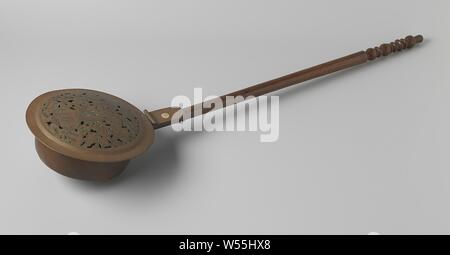 Bedpan with flower vase and birds, The object consists of six parts: the wrought iron ring, the container, the lid, the hinge and the wooden handle. Container, lid and hinge are made of copper plate. The convex lid, the center point of which has remained visible and which has been lowered around a red copper reinforcement with a vertical edge, has a stylized and cut-out decor of a vase with a flower surrounded by birds. The vase shows a homely scene, including a table and chair, a painting and a cupboard. The wooden handle is profiled at the bottom, ribbed at the top. The stem was probably Stock Photo