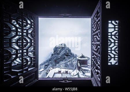 Aerial view of the Wudang Mountains covered with snow in a sea of clouds to create a fairyland-like world in Shiyan city, central China's Hubei provin Stock Photo