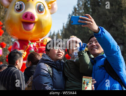 Tourists crowd the Ditan Park to attend a temple fair at Ditan Park during the Chinese Lunar New Year, also known as Spring Festival, in Beijing, Chin Stock Photo