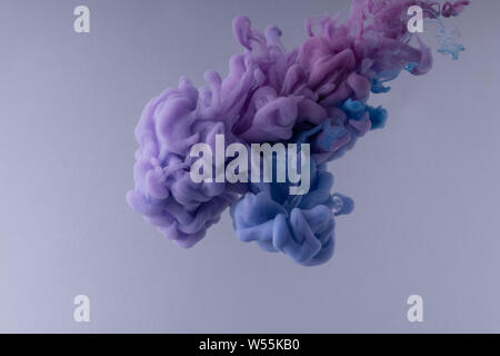 Colorful Ink swirling in water. Cloud of silky ink on white background. underwater. Stock Photo