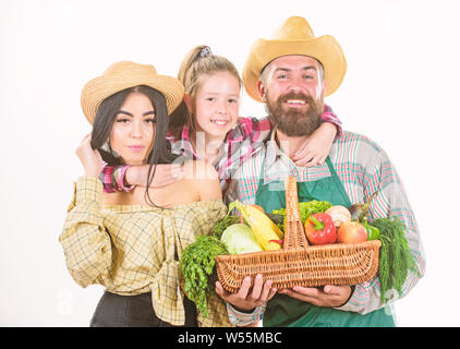 Family rustic farmers proud of fall harvest. Grown with love. Parents and daughter celebrate harvest. Harvest festival concept. Family farmers gardeners vegetables harvest isolated white background. Stock Photo