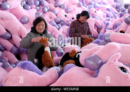 Chinese workers make stuffed toys at a toy factory in Lianyungang city, east China's Jiangsu province, 21 February 2019.   China has posted a surprise Stock Photo