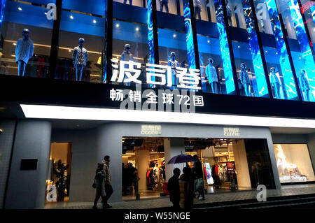 Pedestrians walk past a store of Bosideng International Holdings