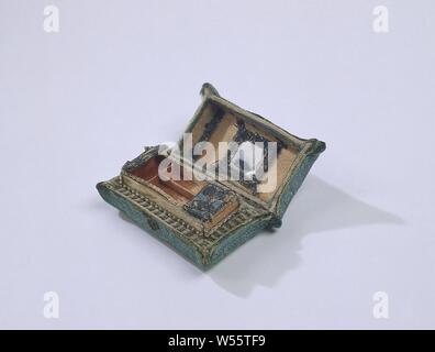Sewing cushion, basic form made of a rectangular box of cardboard with open lid, exterior covered with green silk damask, basic form made of a rectangular box of cardboard with open lid and division into reclosable boxes compartments. On the outside covered with green silk damask, adorned with a thin green piping, trimmed with a tassel on the combined corners. a paper heart as a 'lock plate'. The lid and inside compartments are covered with pink satin, decorated with silvergalon, and strips of green / pink satin and blue-pink trims. The lids of two compartments are covered with cream colored Stock Photo