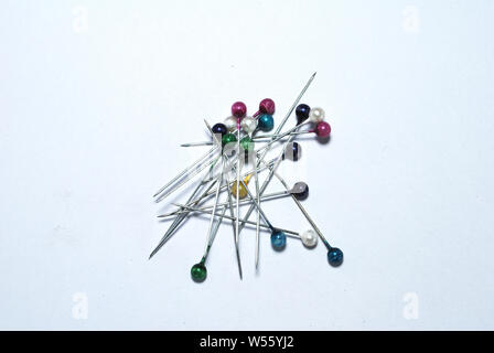 Many colorful pins isolate on white background Stock Photo