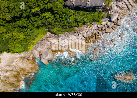 Aerial drone view of boats around the shallow coral reef surrounding beautiful tropical islands (Similan Islands) Stock Photo