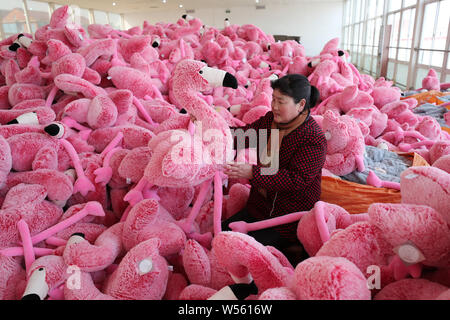 Chinese workers make stuffed toys at a toy factory in Lianyungang city, east China's Jiangsu province, 21 February 2019.   China has posted a surprise Stock Photo