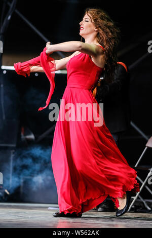 Malmesbury, Wiltshire, UK. 26th July 2019. CGS Canzoniere Grecanico Salentino performs on the Open Air Stage WOMAD Festival (World of Music Arts and Dance) on Friday 26 July 2019 at Charlton Park, Malmesbury. Pictured: Silvia Perrone, dance. Picture by Julie Edwards. Credit: Julie Edwards/Alamy Live News Stock Photo