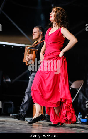 Malmesbury, Wiltshire, UK. 26th July 2019. CGS Canzoniere Grecanico Salentino performs on the Open Air Stage WOMAD Festival (World of Music Arts and Dance) on Friday 26 July 2019 at Charlton Park, Malmesbury. Pictured: Silvia Perrone, dance. Picture by Julie Edwards. Credit: Julie Edwards/Alamy Live News Stock Photo