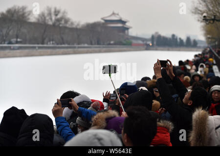 Photography enthusiasts take pictures of the Turret at the Palace Museum, also known as the Forbidden City, in the snow in Beijing, China, 14 February Stock Photo