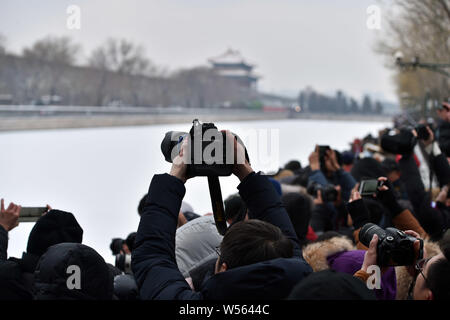 Photography enthusiasts take pictures of the Turret at the Palace Museum, also known as the Forbidden City, in the snow in Beijing, China, 14 February Stock Photo