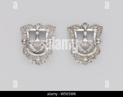 Pair of belt buckles, A pair of silver belt buckles. Asymmetrical in shape and decorated with curls., anonymous, Schoonhoven, 1788 and/or 1808, silver (metal), h 4.5 cm × w 5.5 cm × d 1.1 cm Stock Photo