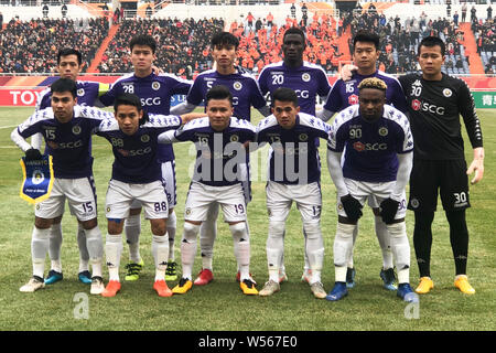 Players of the starting line-up of Vietnam's Hanoi FC pose for photos before their qualifying match against China's Shandong Luneng Taishan F.C. durin Stock Photo